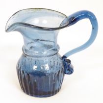 A blue glass cream jug with loop handle. North East England c.1830. 4" high Please Note - we do