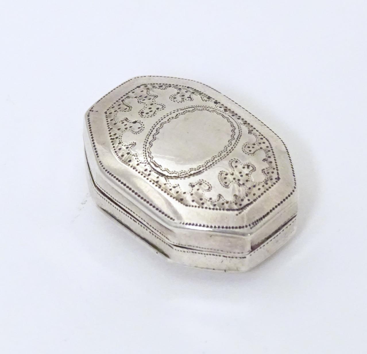 A Geo III silver vinaigrette with engraved decoration opening to reveal gilded interior and