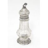 A Continental cut glass pepper pot engraved floral and foliate detail and silver mounts, marked