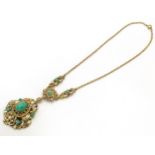 A Continental gilt metal pendant and chain set with central cabochon and with enamel and bead