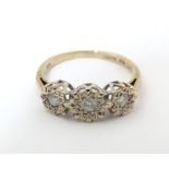 A 9ct gold ring set with a trio of diamonds. Ring size approx. K 1/2 Please Note - we do not make
