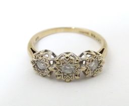 A 9ct gold ring set with a trio of diamonds. Ring size approx. K 1/2 Please Note - we do not make
