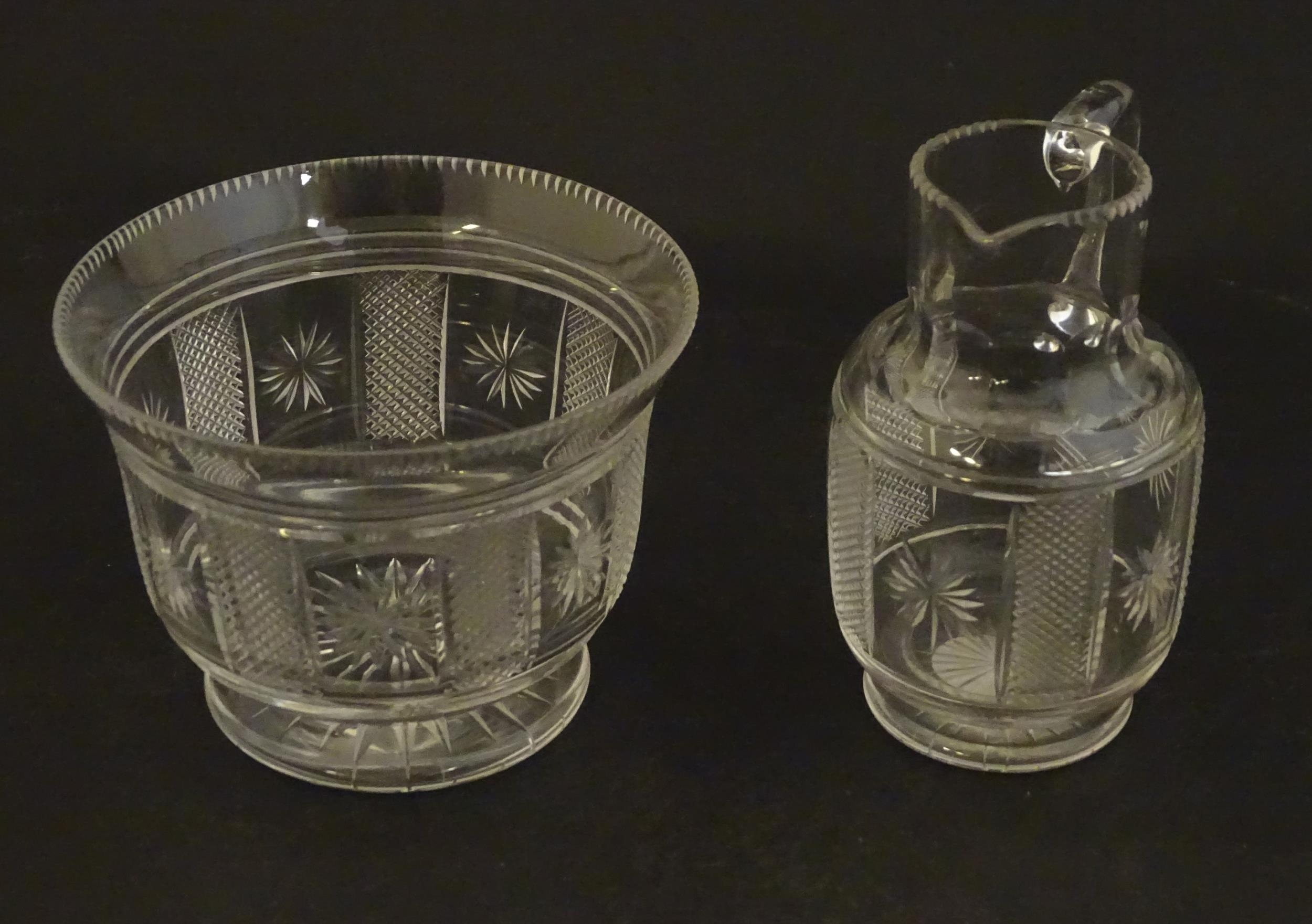 A Victorian glass cream jug and sugar bowl with cut decoration. The jug 3 1/4" high (2) Please