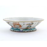 A Chinese footed bowl of lozenge form decorated with figures, vases and Character marks / script.