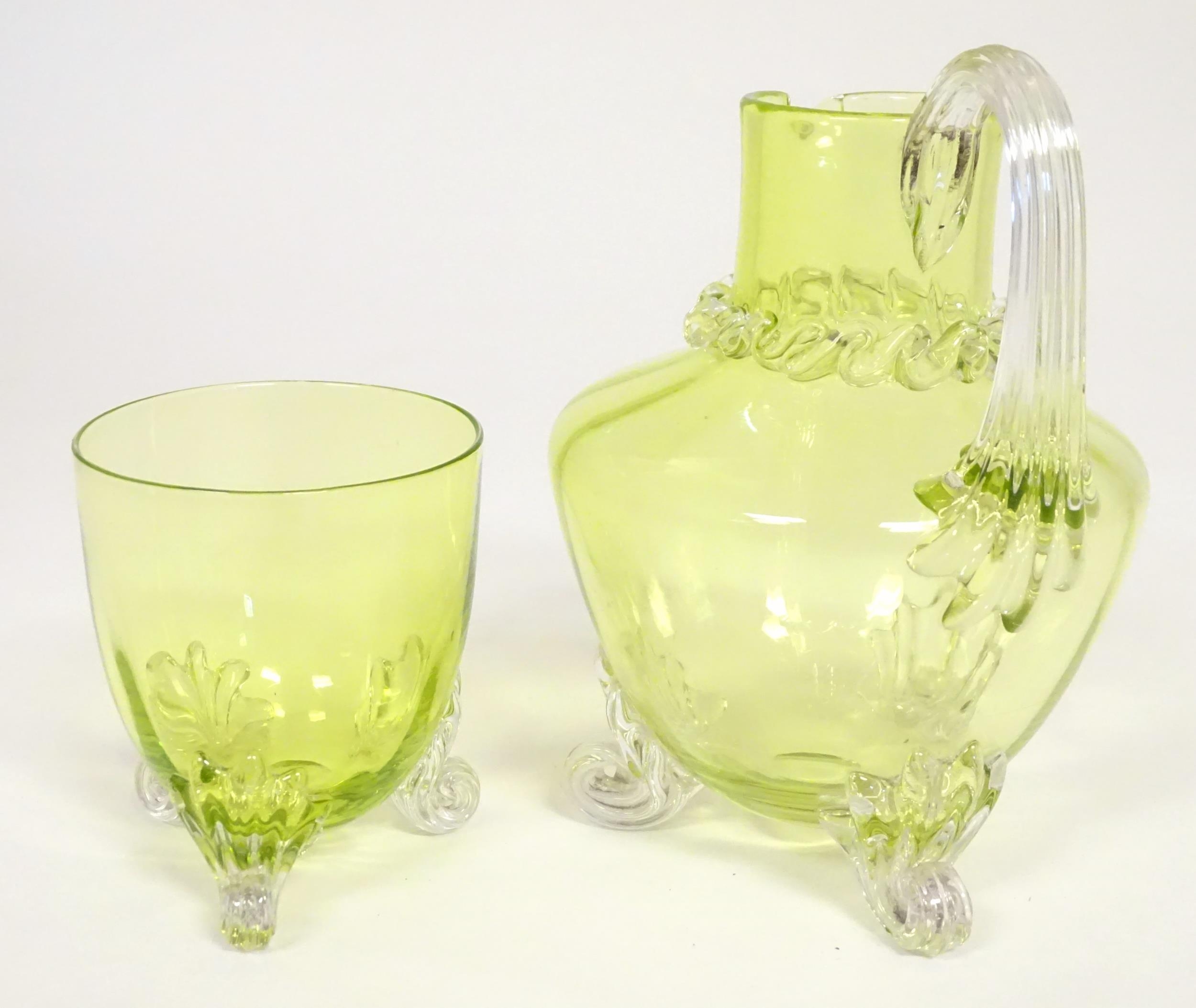 A yellow glass water jug with clear glass handle and feet, together with a matching glass. The jug 6 - Image 3 of 7