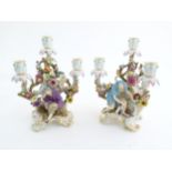 A pair of late 19thC Meissen three branch figural and floral candelabras, one depicting the Greek