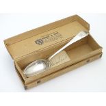 A silver teaspoon hallmarked Sheffield 1904 maker W. S. Savage & Co. with a card box printed with