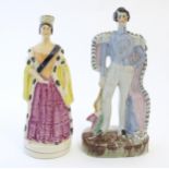 Two Victorian Staffordshire pottery figures depicting Prince Albert, and Queen Victoria. Largest