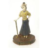 An early 20thC novelty cast iron door porter / door stop formed as an Edwardian lady golfer, with