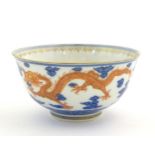 A Chinese blue and white dragon bowl decorated with red dragons, flaming pearl and stylised