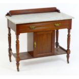 An Aesthetic movement marble topped mahogany washstand, having a shaped upstand above a marble top