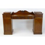 A mid 19thC mahogany double pedestal sideboard of small proportions, having a shaped upstand with