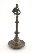 An Indian / Deccan cast temple style oil lamp with turned column surmounted by a Hamsa bird. Approx.