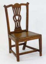An 18thC Chippendale childs chair of peg jointed construction with a shaped top rail above a pierced