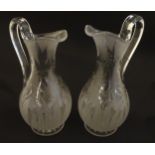 A pair of 19thC jugs with etched decoration depicting floral and foliate detail probably by