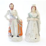 A pair of large Victorian Staffordshire pottery flat back figures depicting the Queen of England,