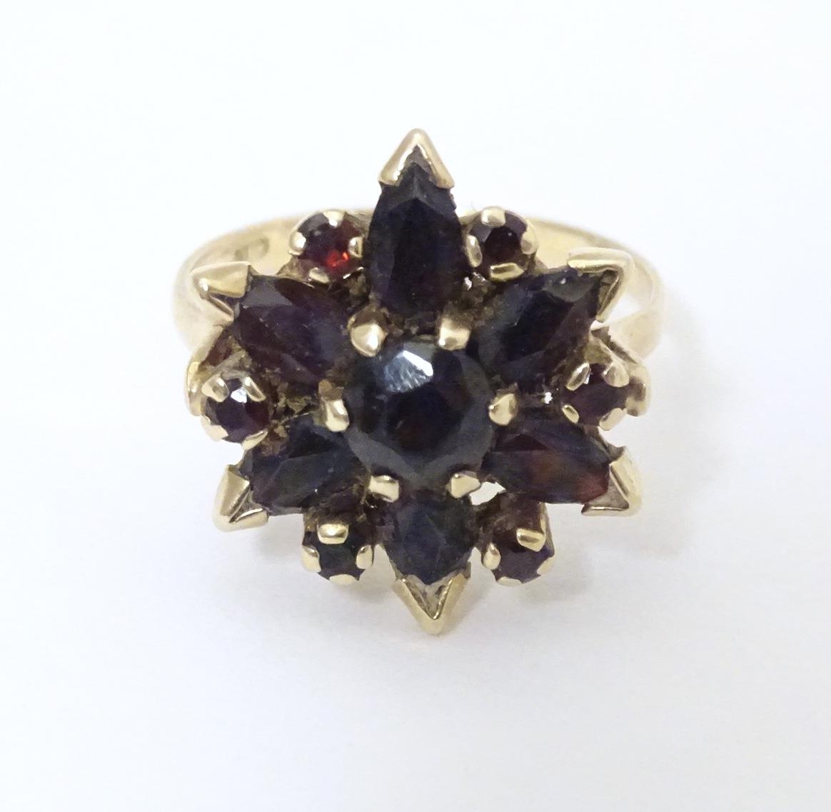 A 9ct gold ring set with garnets. Ring size approx R Please Note - we do not make reference to the - Image 7 of 7