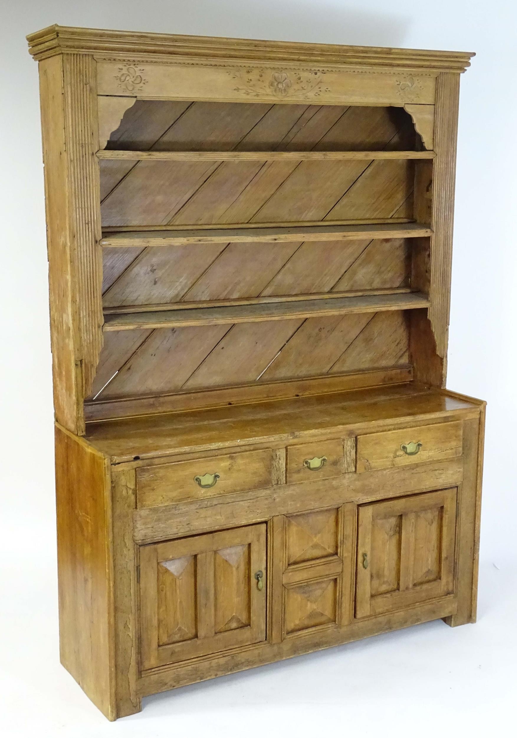 A 20thC pine dresser with a moulded cornice above floral carving flanked by reeded pilaster - Image 2 of 10