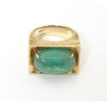 A 14ct gold ring set with jade cabochon. Ring size approx H 1/2. Please Note - we do not make