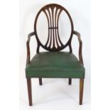 An 18thC mahogany Hepplewhite open armchair with an oval back rest having a pierced fan splat