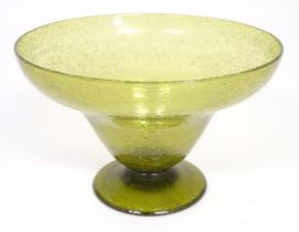 A green glass pedestal bowl with bubble inclusions. Approx 11 1/2" diameter x 7 1/2" high Please