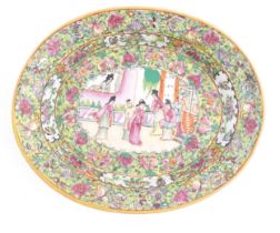 A Cantonese / Chinese famille rose dish of oval form, the centre decorated with figures, bordered by