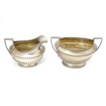 A silver sugar bowl and cream jug hallmarked London 1905, maker Goldsmiths & Silversmiths Company
