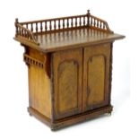 A 19thC walnut galleried cabinet, having turned finials making up the gallery to the top and