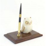 A late 20th / early 21stC pen holder with ceramic owl on a wooden base. Approx. 6" wide Please
