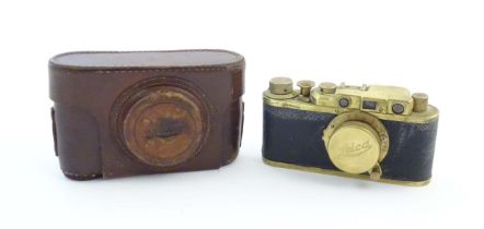 A mid 20thC Russian copy 'Leica II(D) Olympiada' 35mm film camera, in gilt finish and leather
