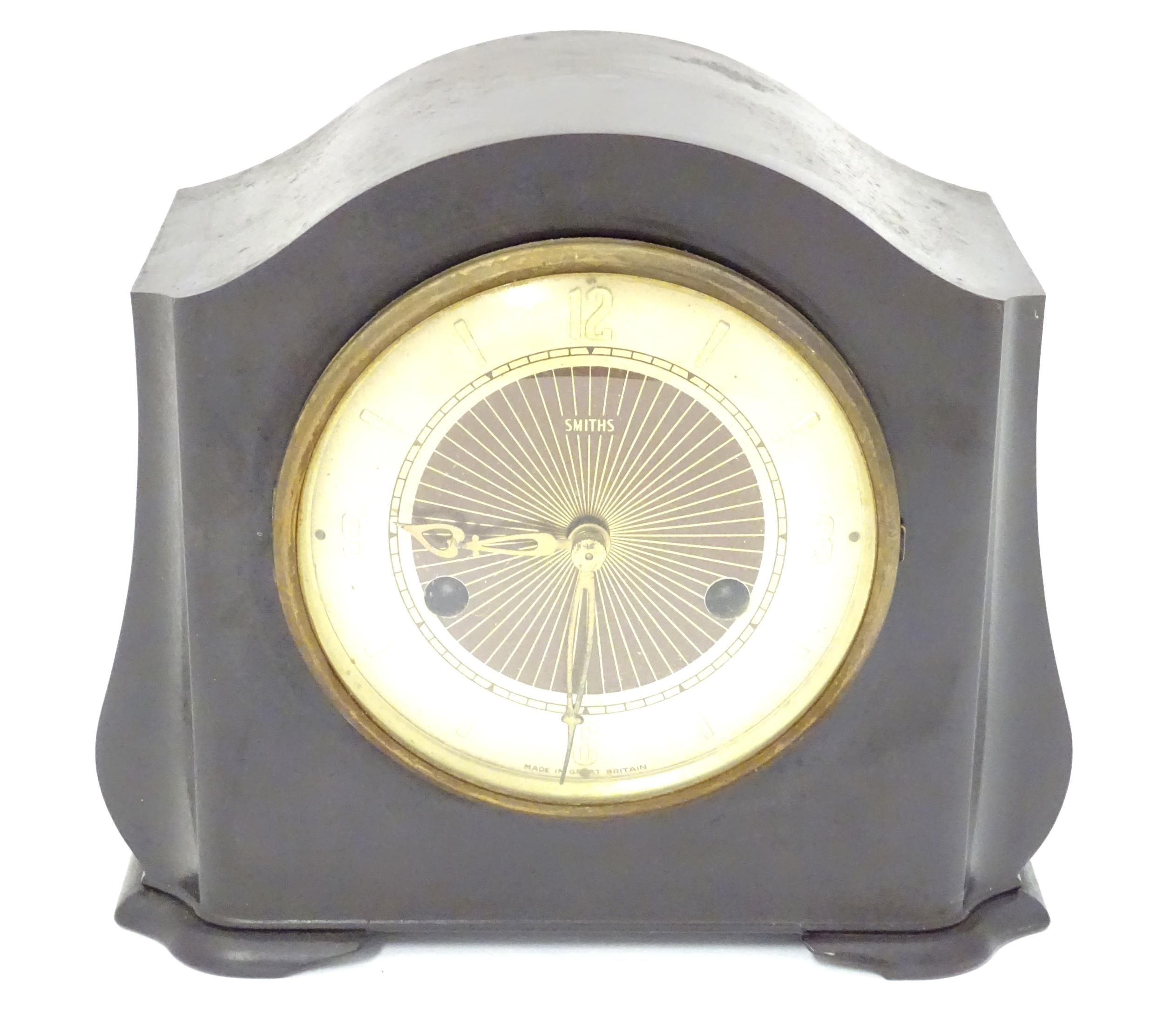 A Bakelite cased mantel clock by Smiths. 7 1/4" high Please Note - we do not make reference to the