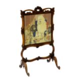 A mid / late 19thC mahogany fire screen with a carved floral top and a pierced hand hold above a