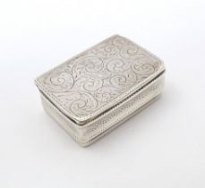 A silver pill box with engraved decoration, hallmarked Sheffield 2002, maker Carrs of Sheffield Ltd.