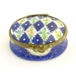 A 19thC Bilston / Battersea enamel pill box of oval form with a waisted body, the lid decorated with