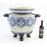 A large Victorian Minton blue and white jardiniere / planter with twin handles standing on four