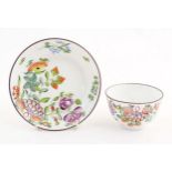A 19thC English porcelain tea bowl and saucer with hand painted floral and foliate decoration. The
