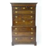 A Georgian chest on chest with a moulded cornice above three short drawers and six long graduated