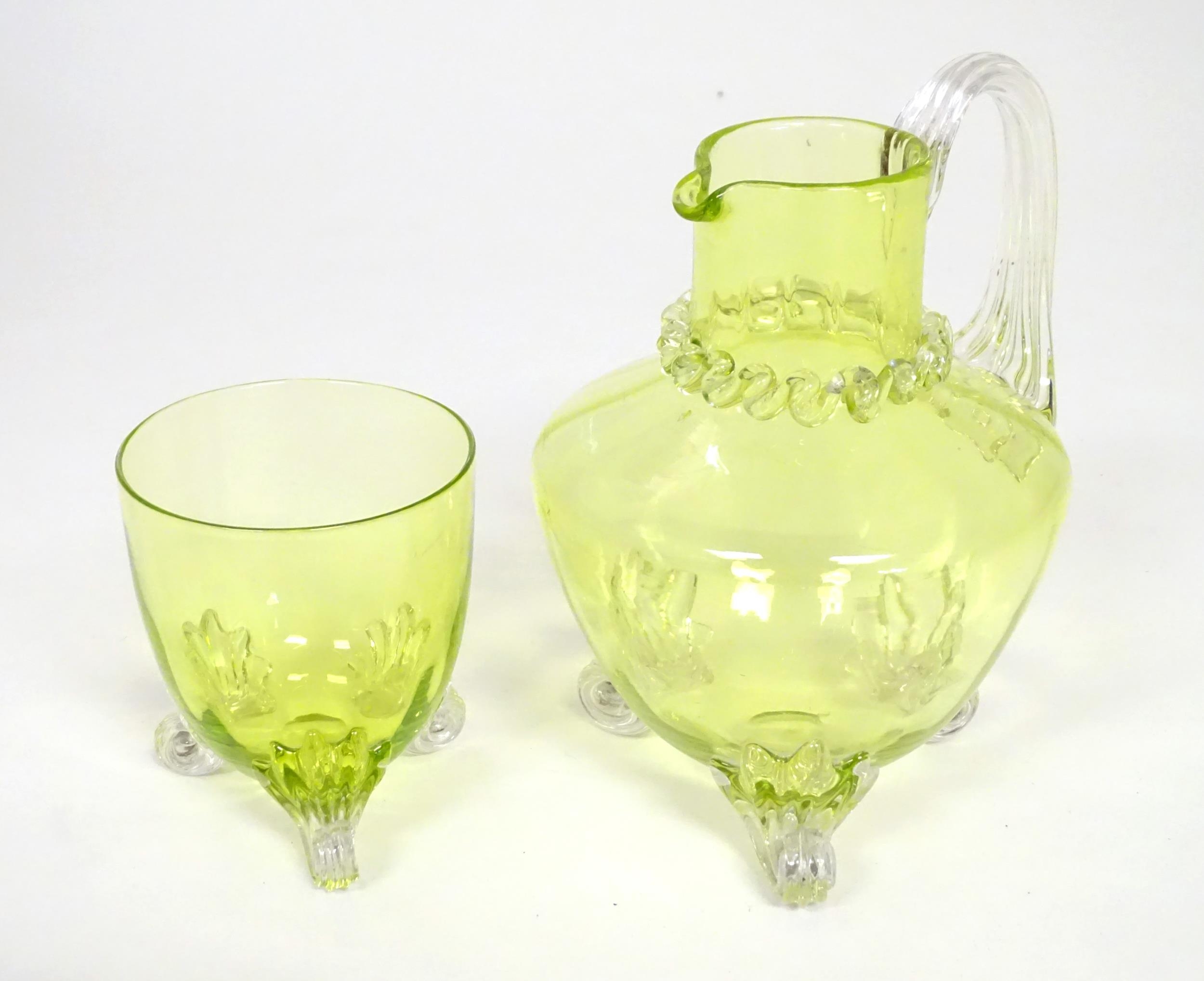 A yellow glass water jug with clear glass handle and feet, together with a matching glass. The jug 6 - Image 2 of 7