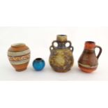 Four West German vases to include a vase with banded decoration, a twin handled vase, a single
