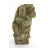 A Chinese carved soapstone figure depicting the Chinese God of Longevity, Shou Lao holding the peach