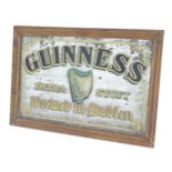A mid 20thC pub advertising mirror for Guinness Extra Stout, decorated with Celtic harp and