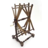 A Victorian wool winder with bobbin turned supports and bone handle. Approx. 24 1/2" high Please