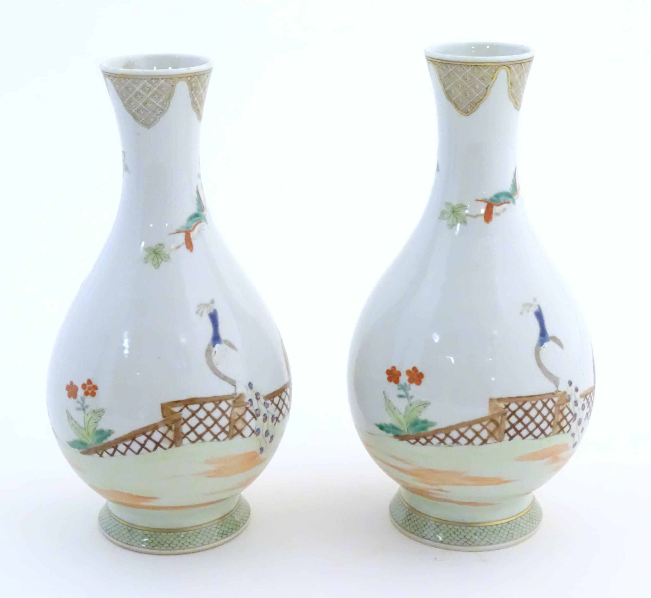 A pair of Chinese famille rose bottle vases decorated with seated figures on a garden terrace, - Image 5 of 6