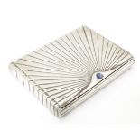 An Art Deco white metal cigarette case with blue sapphire cabochon to clasp. Approx. 4" x 3" x 3/