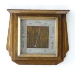An Art Deco oak cased aneroid barometer 12" x 14" Please Note - we do not make reference to the