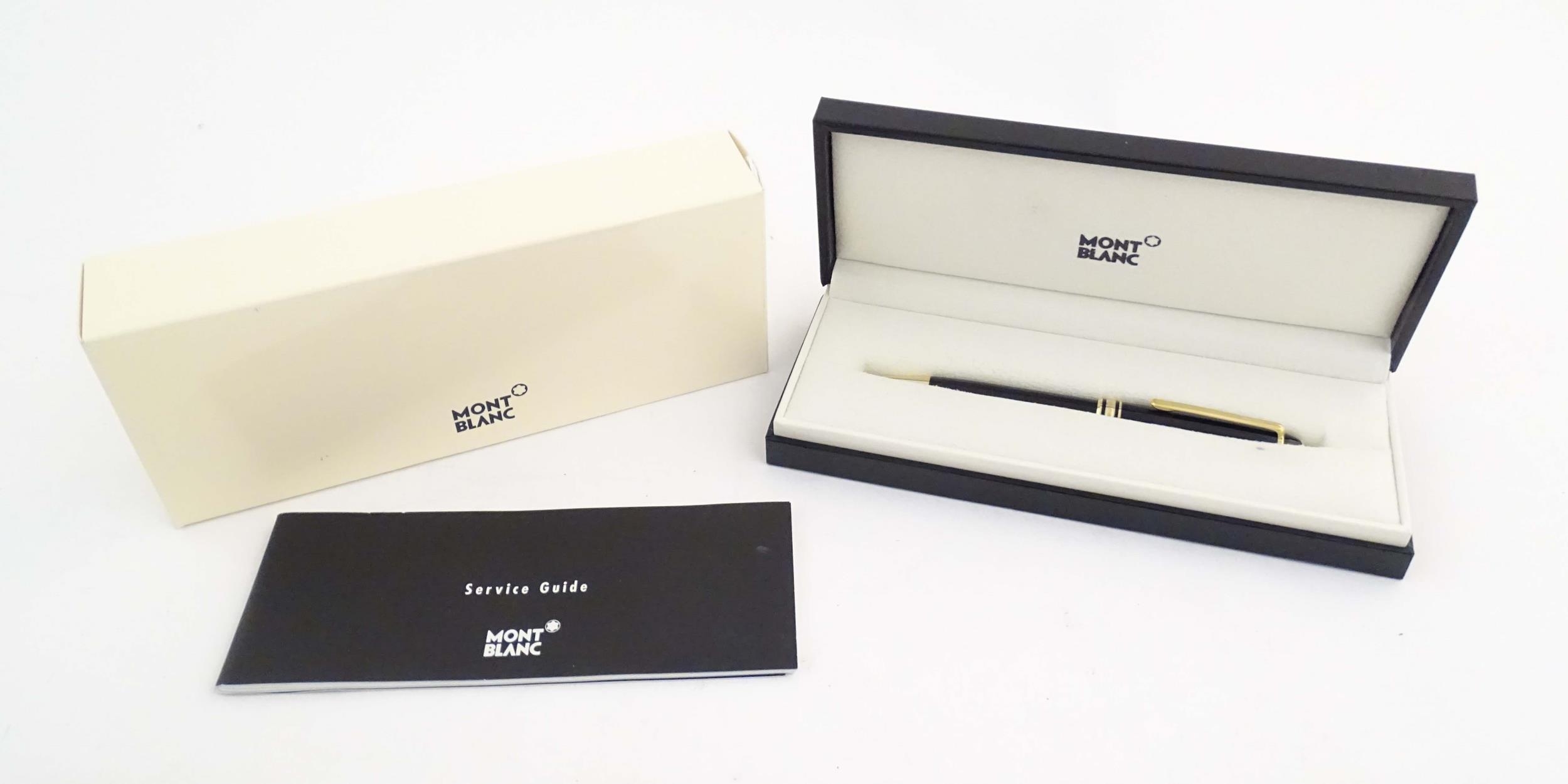 A cased Montblanc 'Meisterstuck' ballpoint pen, in black finish and decorated with gilt banding. - Image 2 of 12