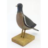 A mid 20thC hand carved and painted Woodpigeon decoy with affixed glass eyes, Approx. 12 1/2" long