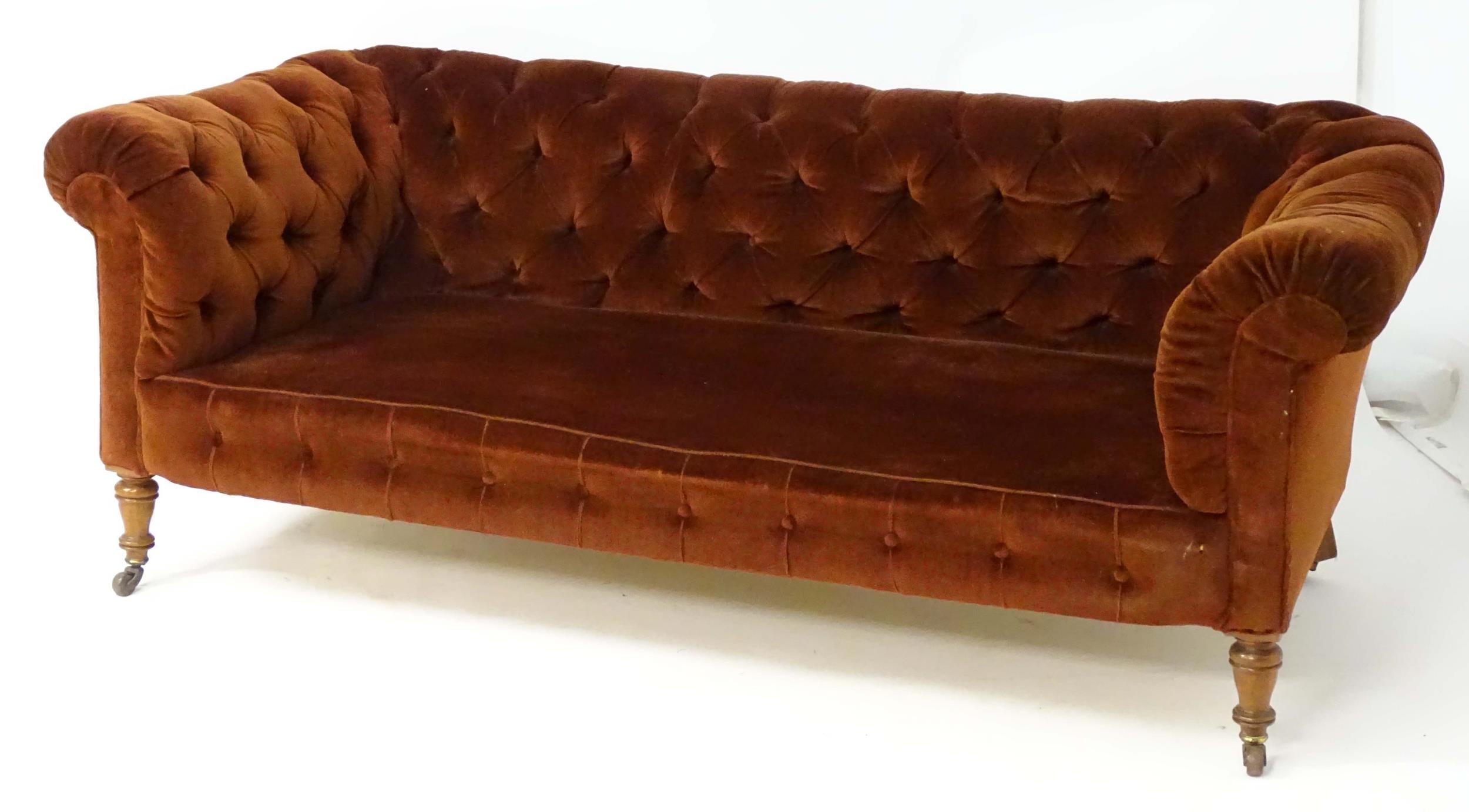 A late 19thC button back chesterfield sofa raised on turned tapering front legs. 81" wide x 37" deep - Image 4 of 5