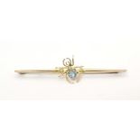 A 9ct gold bar brooch set with spider to centre having a blue stone body 2 1/2" wide Please Note -