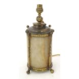 An Arts and Crafts table lamp , the cylindrical alabaster body with brass twist detail on four
